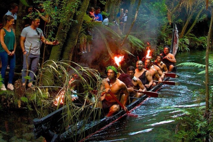 a group of people standing around a fire